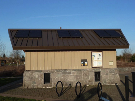Solar panels on the restroom roof – sign on building explains benefits of solar energy